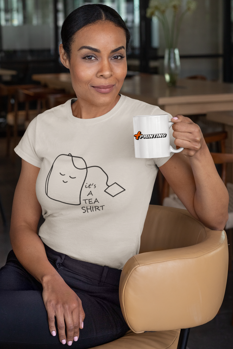 t-shirt-mockup-of-a-woman-sitting-on-a-chair-holding-an-11-oz-coffee-mug-31705